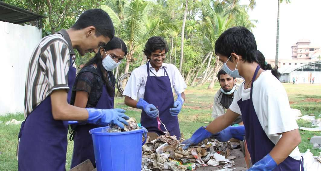 Students in aprons segregating waste
