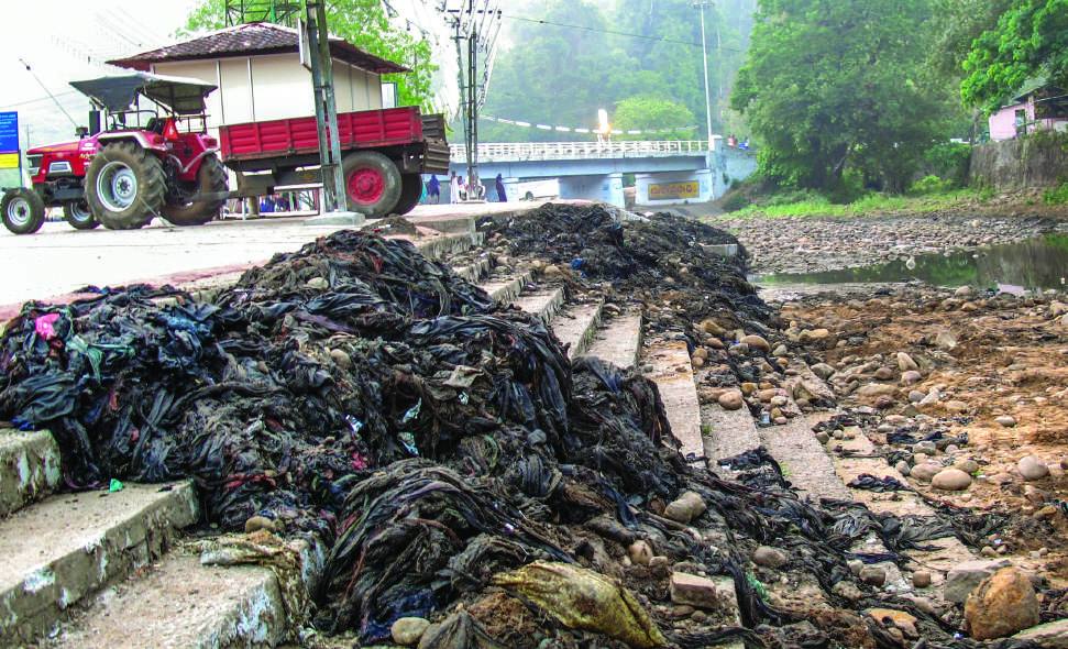 Before: discarded clothes heaped on the river steps