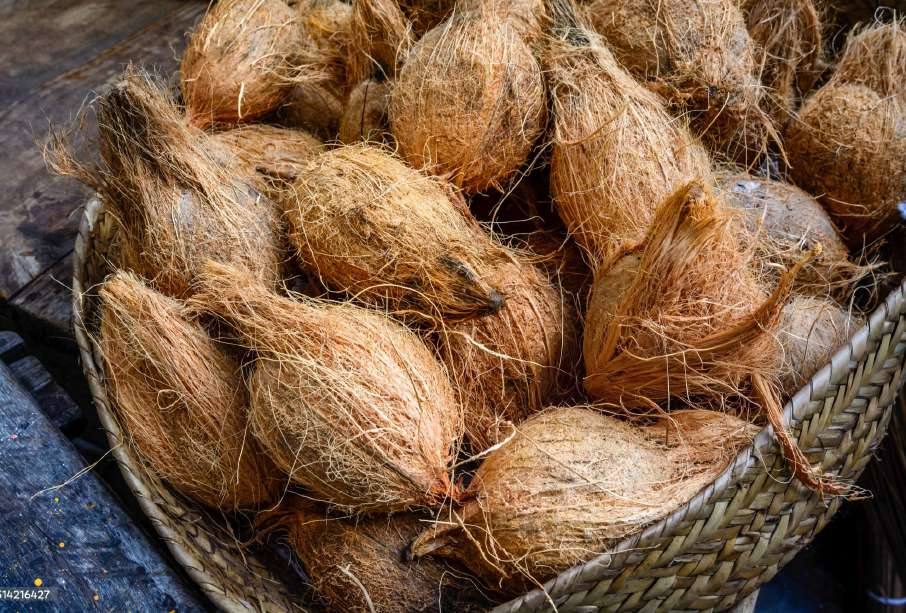 A basket of husked coconuts