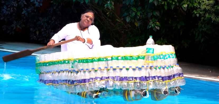 Amma at the helm of a boat made from plastic bottles in a pool